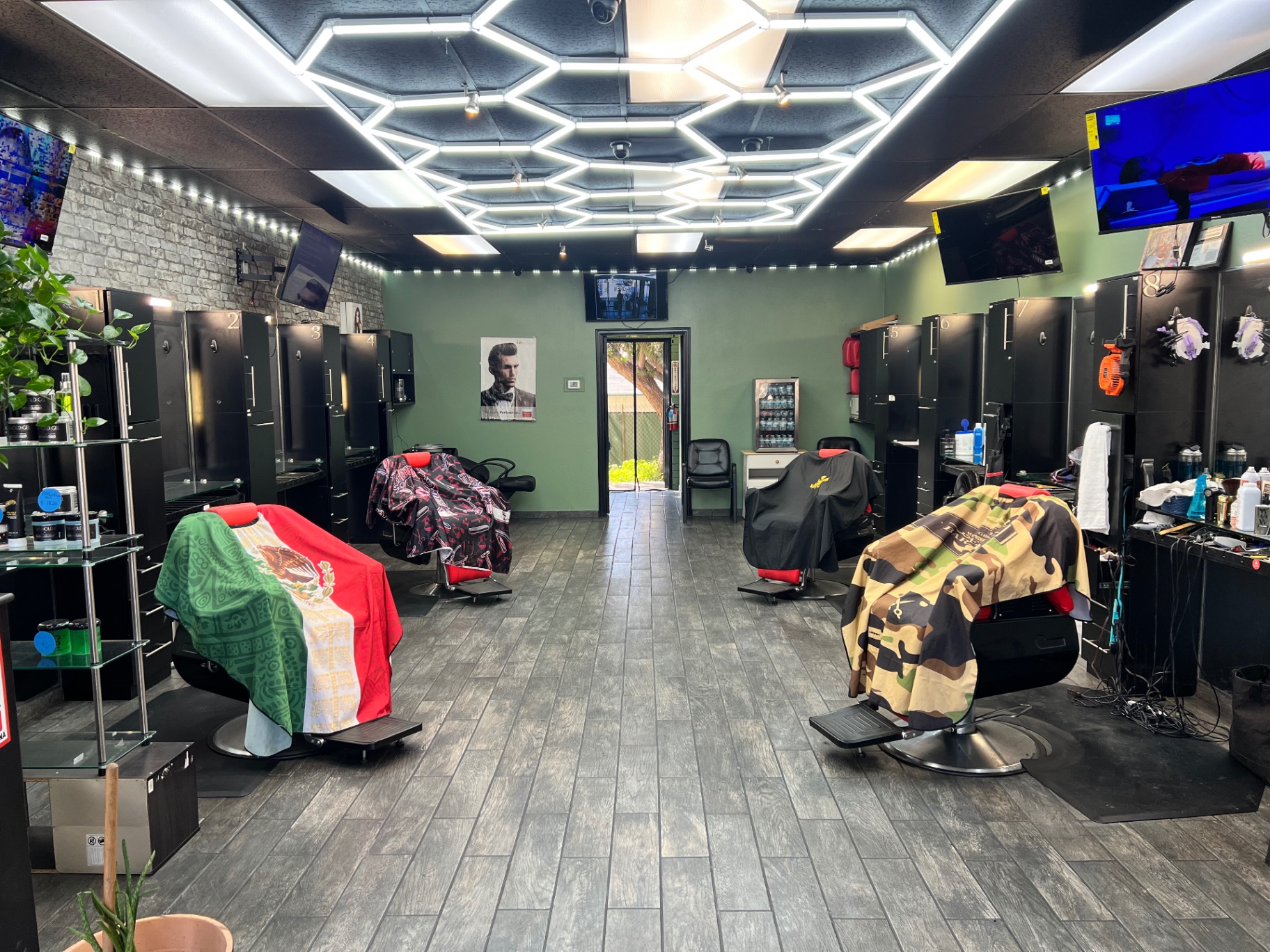 Inside Issa Barbershop — barber chairs, mirrors, and neon ceiling lights